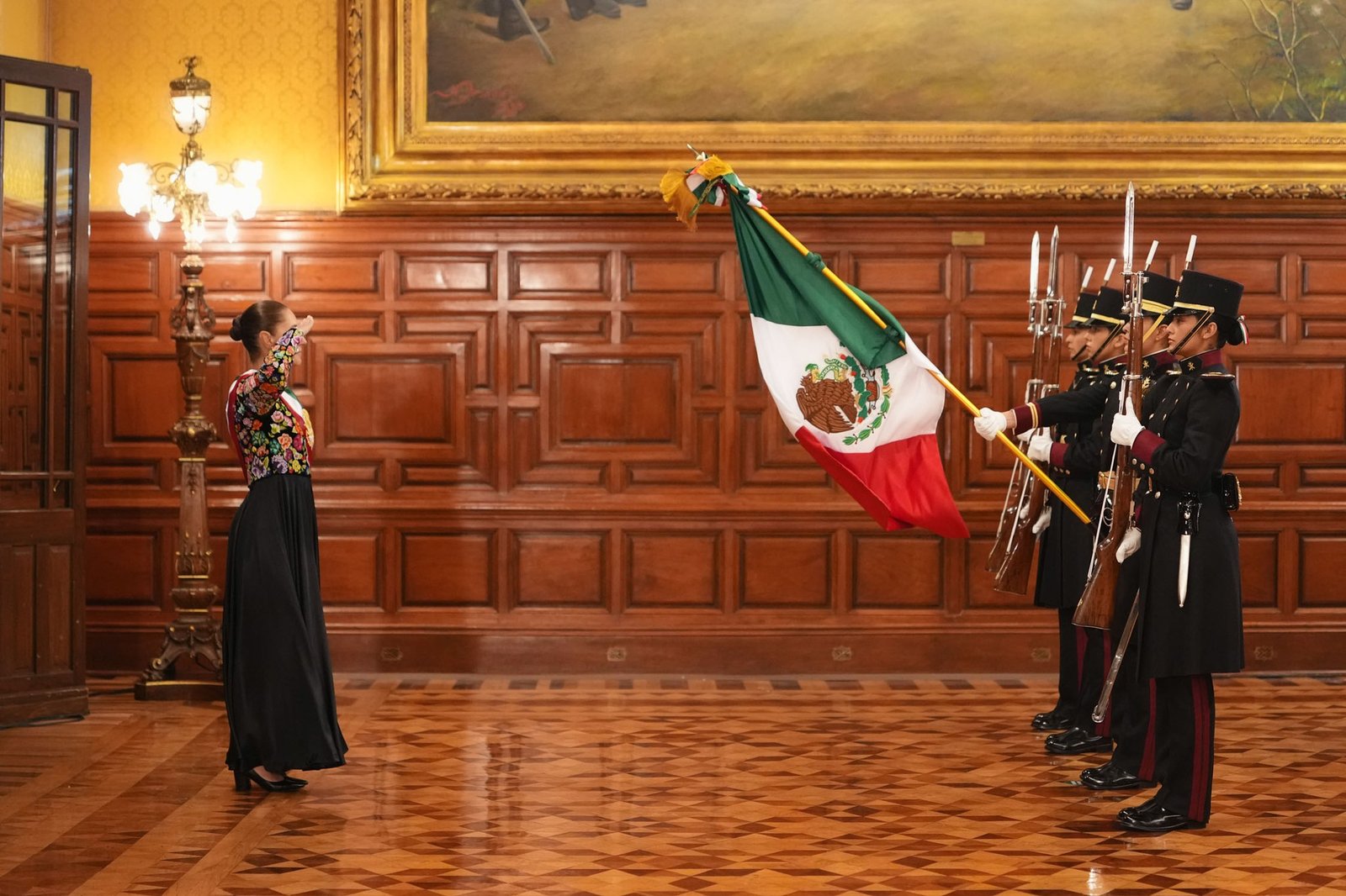 An honor guard presents the national flag inside the National Palace